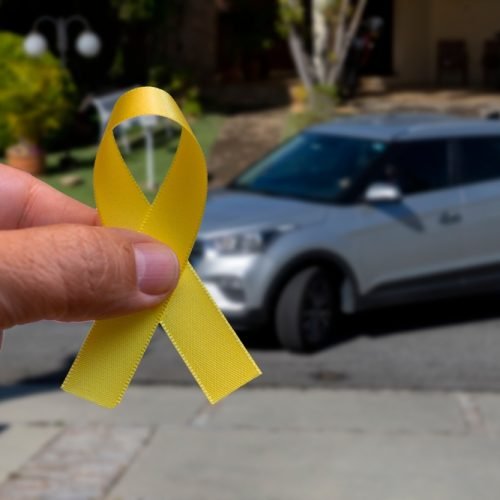 Yellow,May.,Hand,Holding,Yellow,Ribbon.,Traffic,Accident,Prevention,Campaign.