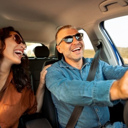 Excited,Playful,European,Couple,In,Sunglasses,Driving,Luxury,Car,,Enjoying