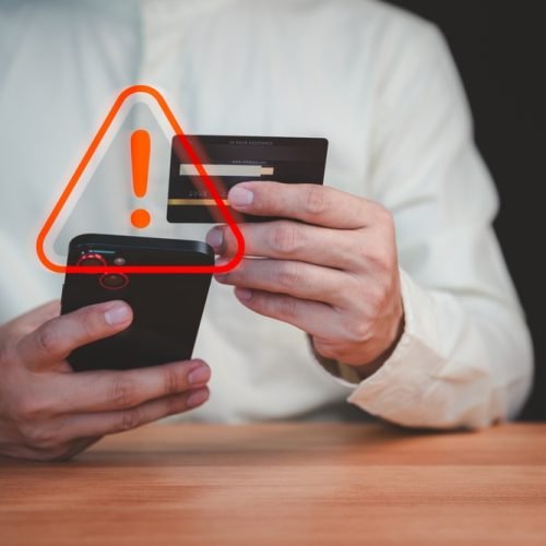 A,Person,Holding,A,Credit,Card,And,Smartphone,With,A